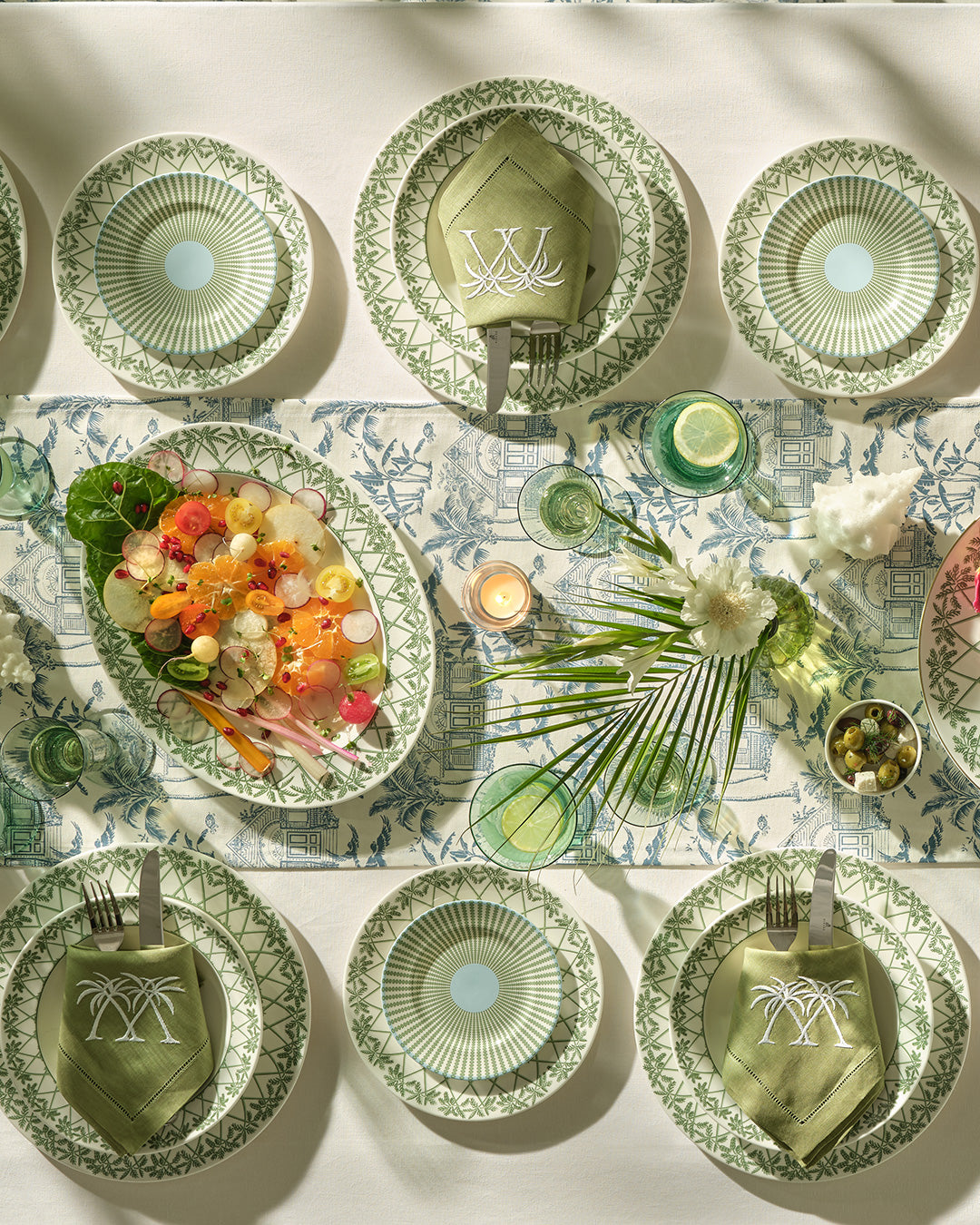Elegant fine bone china dinner set in Palms Sage Green design, featuring oval serving platter and embroidered napkins.