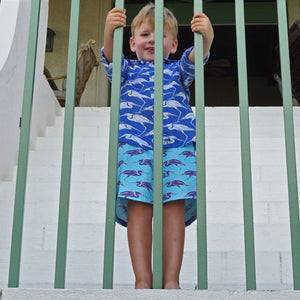 Boys vacation styles in sustainable turquoise blue swim shorts with Egret bird print