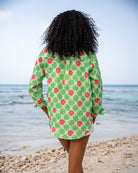 Back view of women's Anastasia oversized linen shirt in Watermelon Green print on the beach
