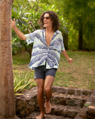 Tropical Banana Tree Blue silk shirt styled open over swim shorts – luxury unisex resortwear by Pink House Mustique.
