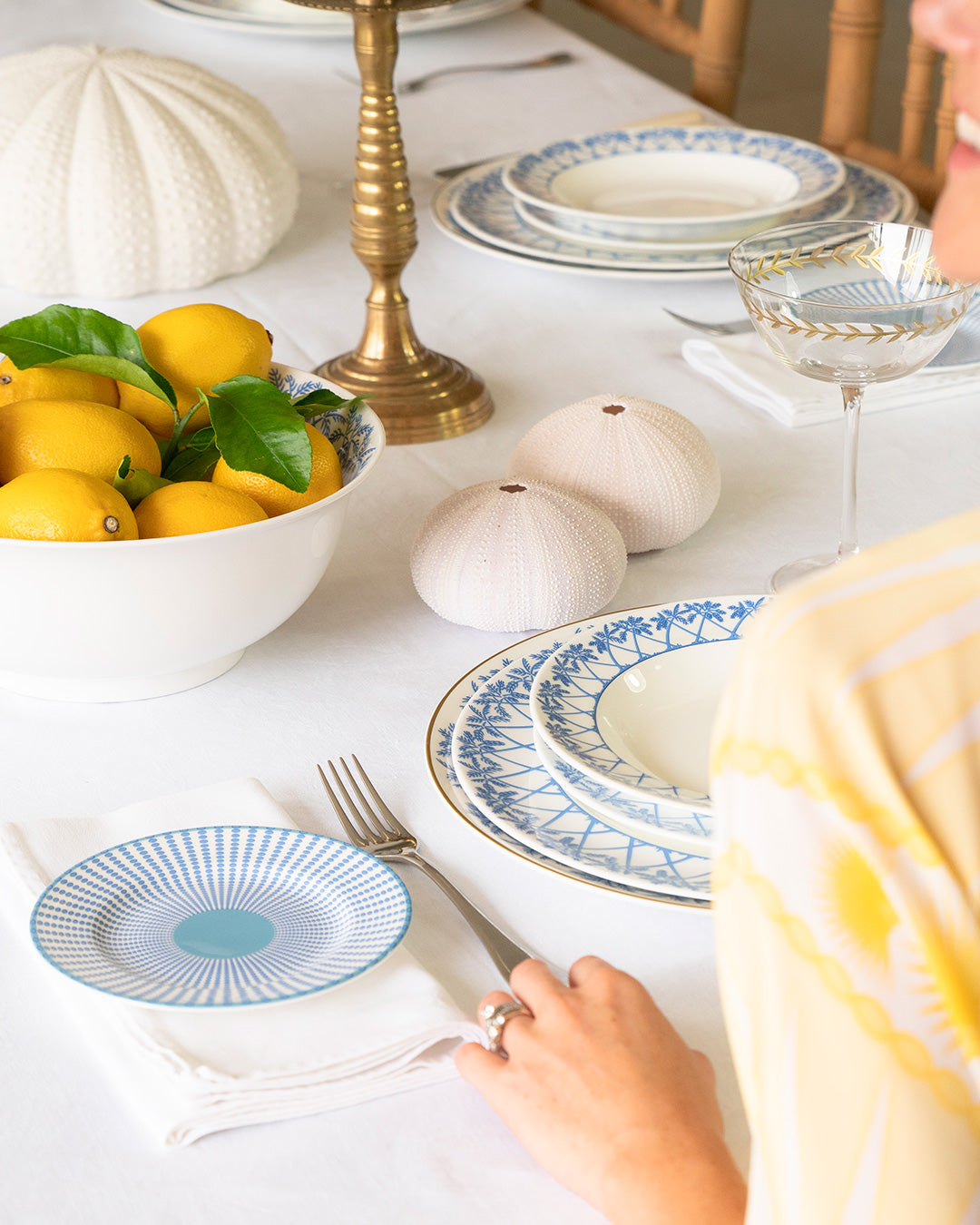 Island-inspired table setting featuring Palms Azure Blue fine bone china and Fan Palm Yellow silk kaftan.