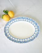 Fine bone china Palms Azure blue oval platter by Lotty B Mustique luxury dinnerware with fresh lemons