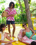 Luxury silk Festival Shirt in Banana Tree Pink worn at Mustique villa with friends, styled with swim shorts and shades