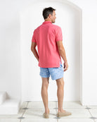 Luxury pink polo shirt and Coral Stone Blue swim shorts from Pink House Mustique Resort 2026.