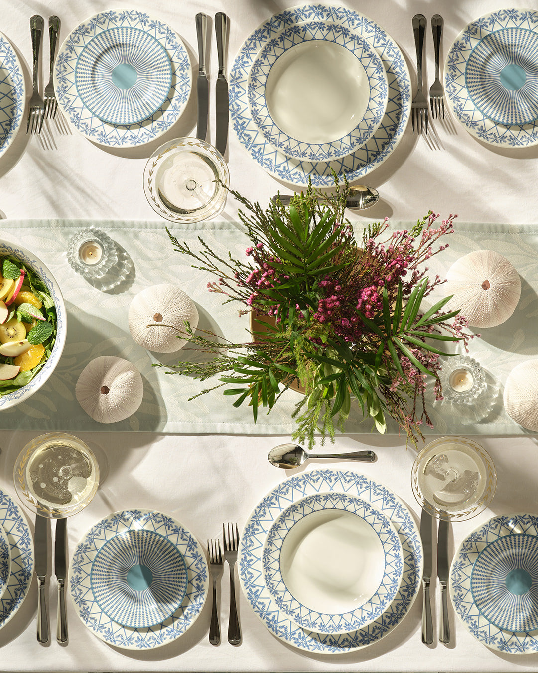 Luxury fine bone china dinner service in Palms Azure Blue — coastal table setting with floral centrepiece.