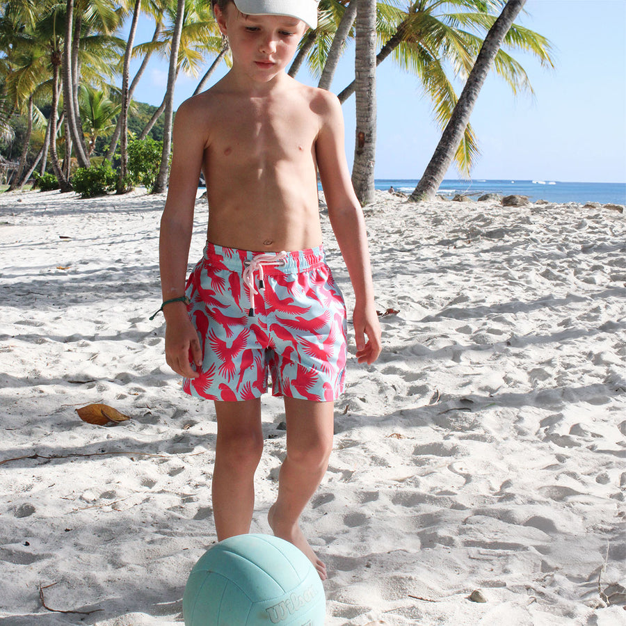 Boys swim shorts in turquoise blue and coral red Striped Shell print by designer Lotty B
