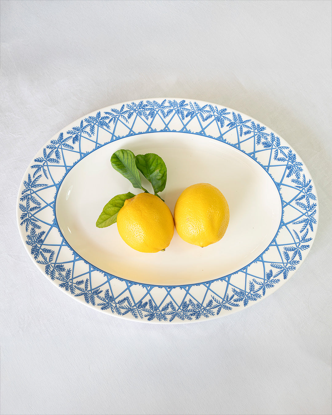Luxury fine bone china oval platter Palms Azure blue by Lotty B Mustique tableware styled with lemons