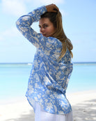 Luxury women’s Iguana Blue linen Kim blouse by Pink House Mustique, breezy beachwear with tropical floral print.