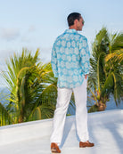 Luxury men’s Agave turquoise linen shirt paired with white linen trousers from Pink House Mustique.