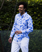 Luxury men’s blue pomegranate print linen shirt styled with white trousers, island-inspired summer outfit