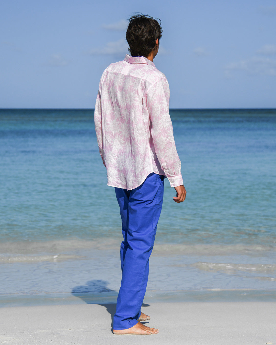 Back view men’s Agave pink linen shirt with dazzling blue linen trousers, Pink House Mustique.