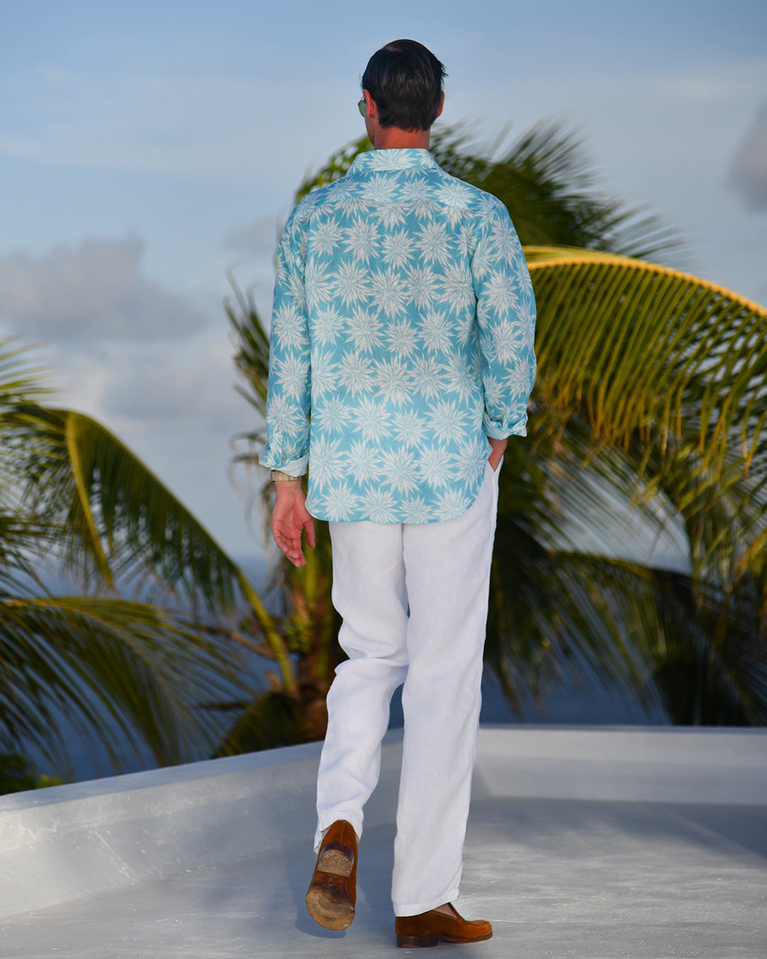 Back view Agave turquoise blue men’s linen shirt on rooftop, Mustique island.