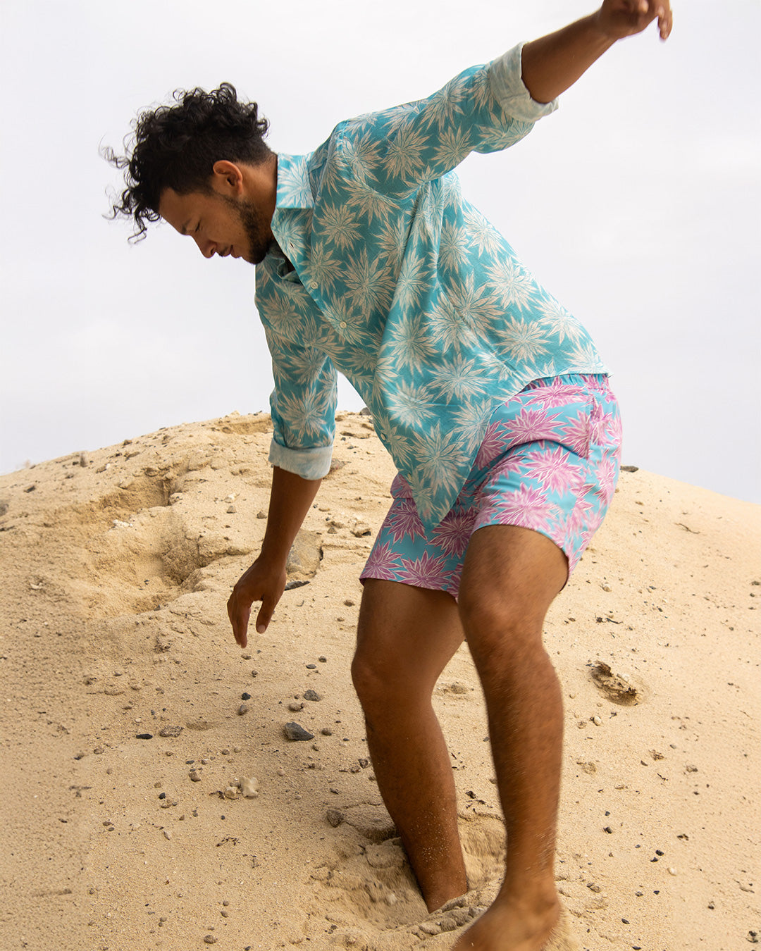Men’s turquoise blue Agave linen shirt with matching pink and turquoise swim shorts by Pink House Mustique.