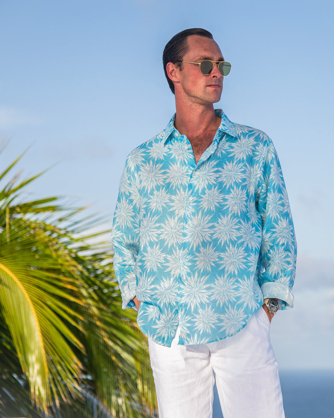 Men’s turquoise blue Agave linen shirt with classic white linen trousers by Pink House Mustique.