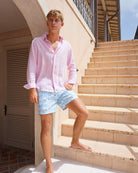 Mustique Mule Multi men’s swim shorts styled with a pale pink linen shirt on Mustique