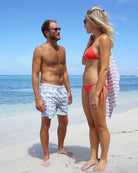 Men’s Mustique Mule red swim shorts on the beach in Mustique