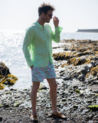Mens pistachio green linen collarless shirt relaxed beach style with monkey print swim shorts, lightweight summer outfit