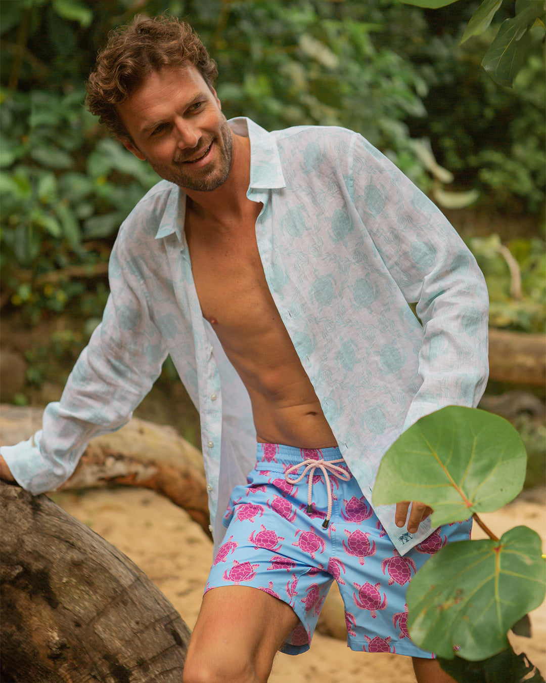 Mens turtle swim shorts pink blue styled with linen shirt luxury resortwear Mustique beach holiday