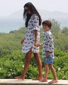 Mother and child walking hand in hand in matching Monkey & Palms print, luxury mini-me resort wear by Pink House