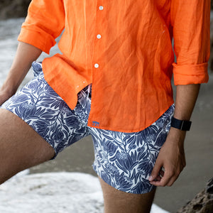 Recycled fabric mens swim shorts in navy blue floral protea print
