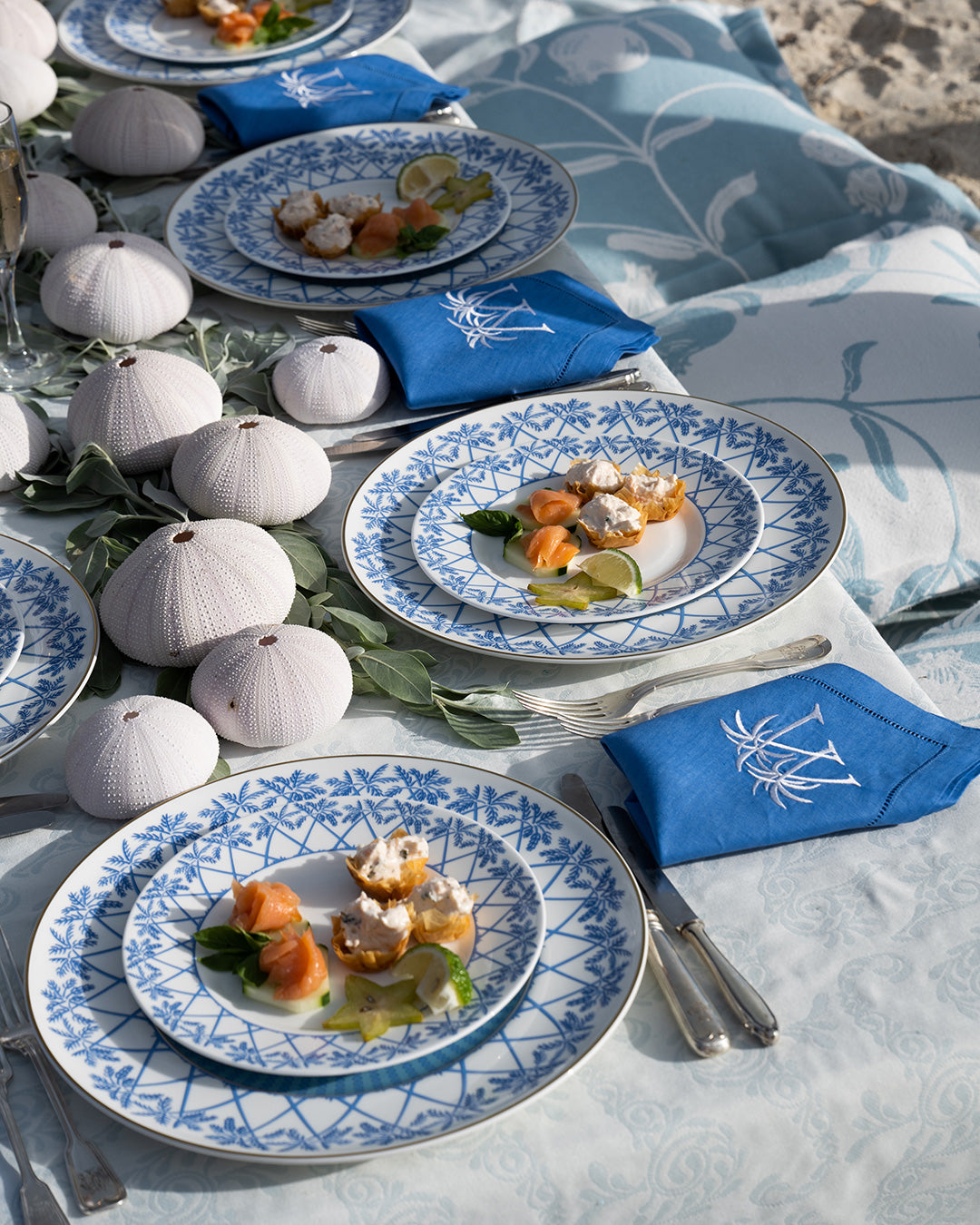 Mustique beach picnic at Lagoon Bay with fine bone china Palms Azure Blue plates and embroidered linen napkins
