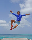 Men’s Mustique Mule red swim shorts worn by the sea on Mustique