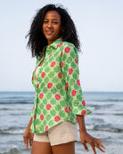 Anastasia women's linen shirt in Watermelon Green print styled with natural shorts by the sea