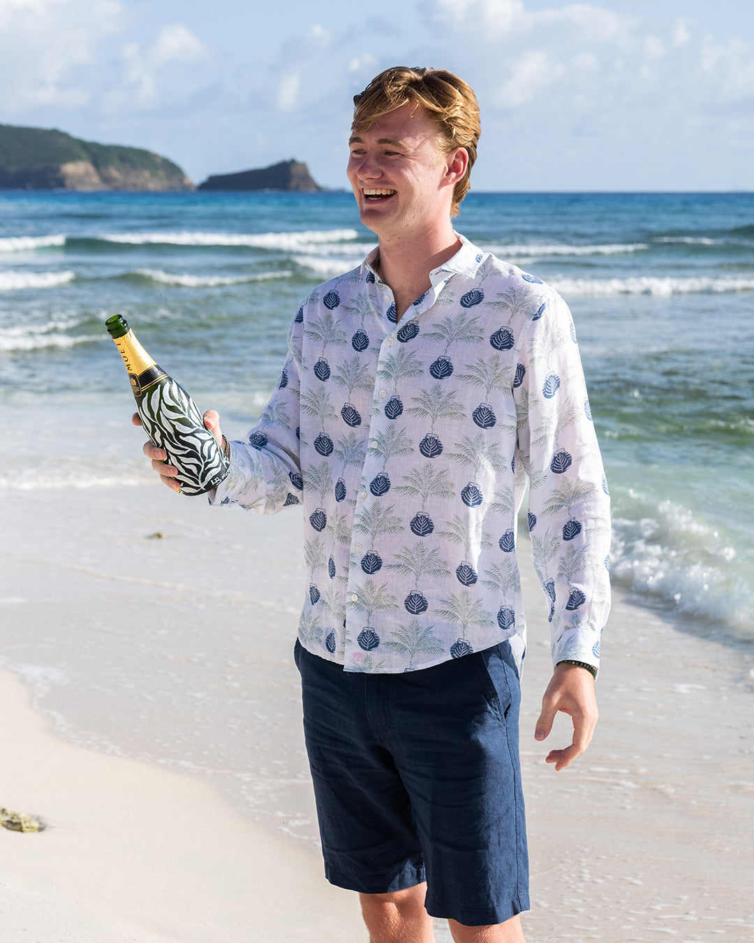 Ocean views and champagne on Pasture Bay in a pure linen shirt in green and navy blue Potted Palm print by designer Lotty B for Pink House