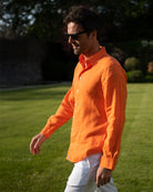 Pink House men’s orange linen shirt styled with white trousers, lightweight summer shirt for warm weather resort dressing