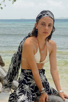 Style a pure chiffon silk sarong in black and white Plantation print as a head scarf and pair with matching silk palazzo pants by designer Lotty B beach vacation on Mustique Island