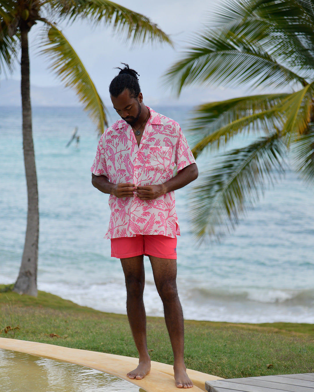 Men's Parrot Pink silk Festival Shirt styled with coral swim shorts at Frenchman's Field Villa Mustique