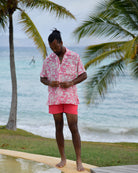 Men's Parrot Pink silk Festival Shirt styled with coral swim shorts at Frenchman's Field Villa Mustique