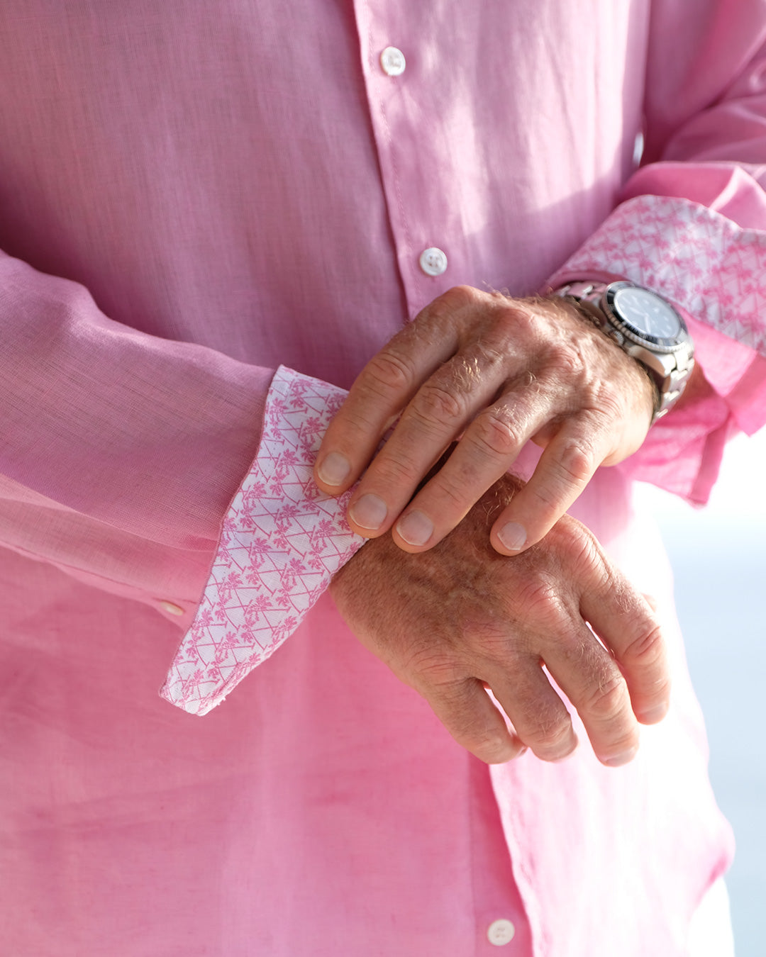 Patterned cuff detail on men's pure linen shirt in bright fuchsia pink by resortwear designer Lotty B Mustique