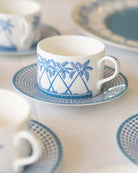 Luxury fine bone china Palms Azure Blue coffee cup and saucer set with tropical palm design in coastal blue tones.