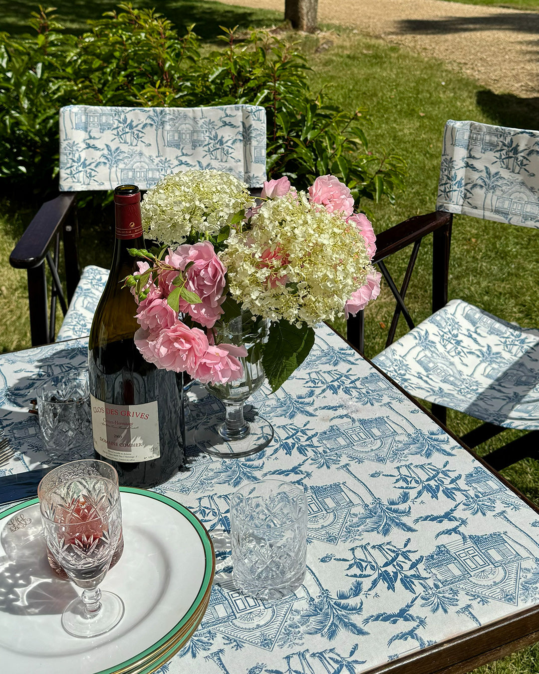 Pink House Toile blue cotton tablecloth and matching chair covers styled for elegant outdoor dining