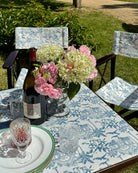 Pink House Toile blue cotton tablecloth and matching chair covers styled for elegant outdoor dining