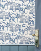 Semley Blue Pink House Toile Wallpaper featuring Caribbean houses, palm trees, parrots and turtles