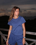 Woman wearing Pink House navy blue pure cotton T-shirt at sunset, relaxed Mustique beach essentials style