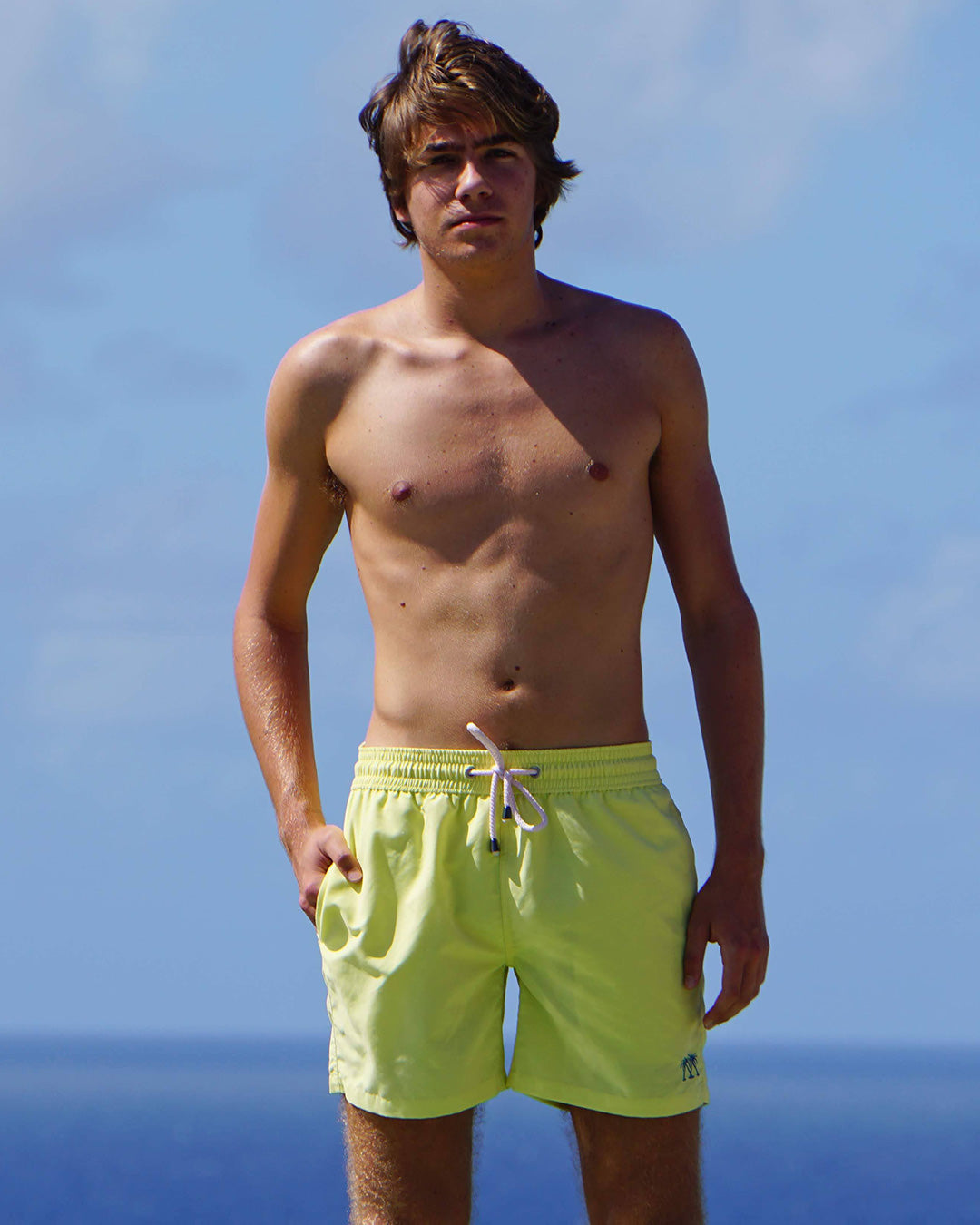 Vacation style in bright yellow swim shorts by designer Lotty B for Pink House at Yemanja Villa Mustique island