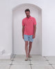 Men’s pink cotton polo and Coral Stone dusk print swim shorts in recycled fabric, Pink House Mustique.