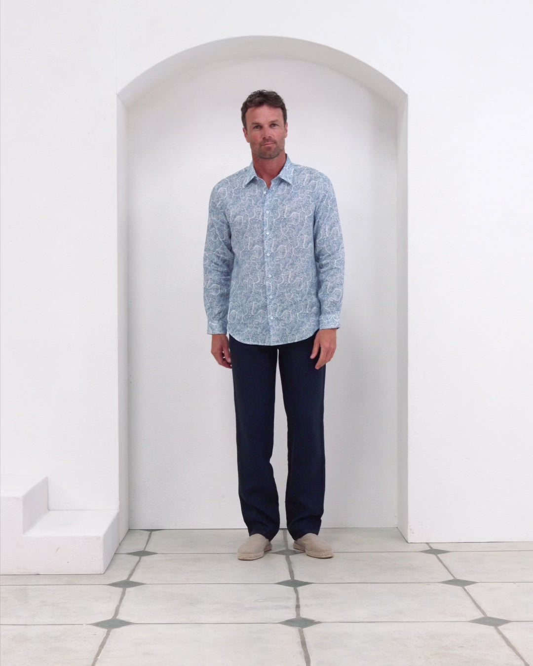 Men’s Coral Stone dusk print linen shirt with Eclipse navy trousers, designed by Lotty B for Pink House Mustique.