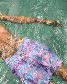Underwater shot of Agave turquoise and pink recycled swim shorts, quick-dry sustainable men’s resortwear.