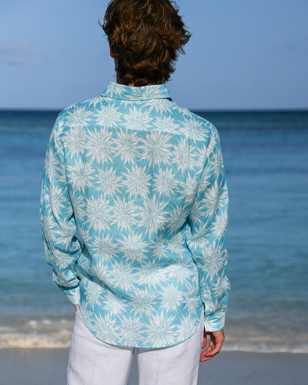 Close-up back of Agave turquoise blue print men’s linen shirt by Pink House Mustique.