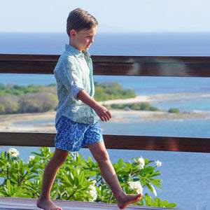Children's island style sustainable quick dry swim shorts in turquoise fern print