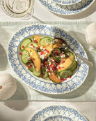Luxury fine bone china oval platter in Palms Azure Blue filled with fresh melon, cucumber, pomegranate salad – Mustique island inspired tableware