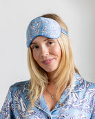 Model wearing silk eye mask in Parrot Blue – tropical print sleep accessory by Lotty B to match silk pajamas