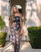 Pure silk chiffon sarong in black and white Plantation pattern worn as wrap skirt by designer Lotty B Mustique Island Resort Wear
