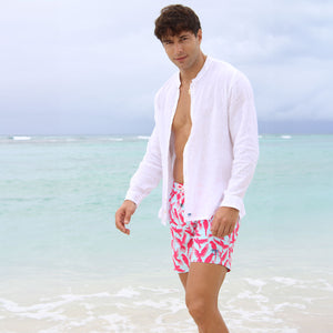 Quick dry sustainable men's swim shorts in turquoise blue and coral red Parrot print by designer Lotty B