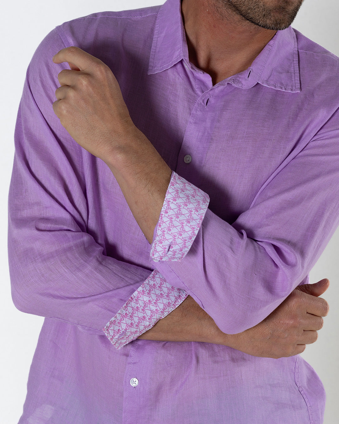 Close-up of men's violet linen shirt with pink and white crossed palm contrast cuff detail – premium lightweight vacation shirt by Lotty B Mustique.