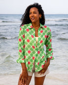 Woman wearing Anastasia oversized linen shirt in Watermelon Green print with natural linen shorts on the beach